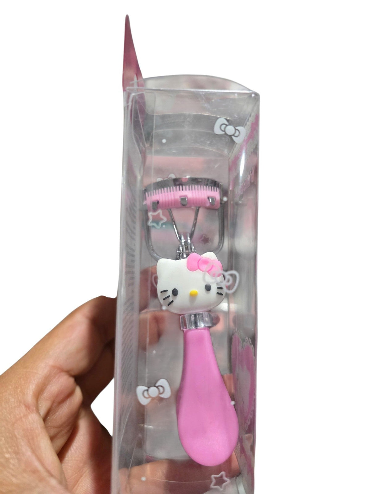 Accesorios by Alexsa Hello Kitty eyelash curler in pink with integrated comb in clear retail packaging