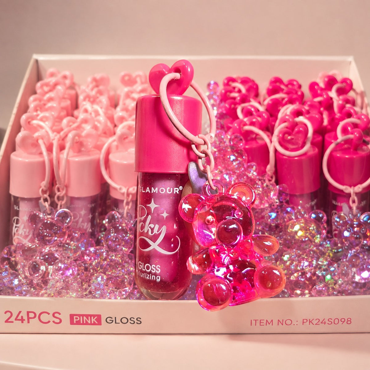 Set de 24 brillos labiales Accesorios by Alexsa en tonos rosa con llavero de osito brillante y fórmula hidratante.
