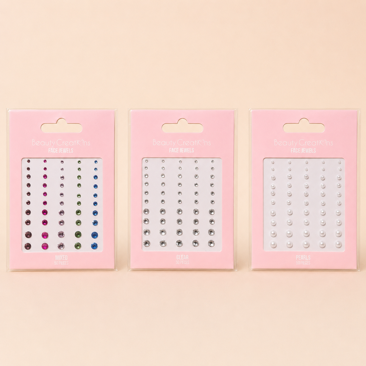 Face Jewels Beauty Creations en variantes Mixed, Clear y Pearls sobre fondo rosa nude, blanco y beige